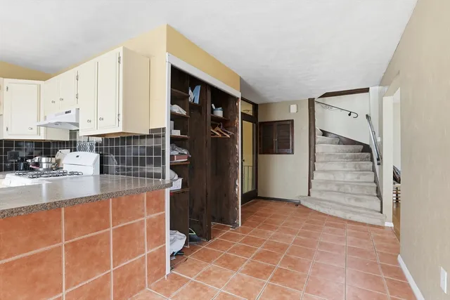 a kitchen with stainless steel appliances a refrigerator and cabinets