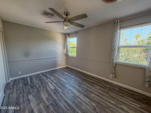 wooden floor in an empty room with a window
