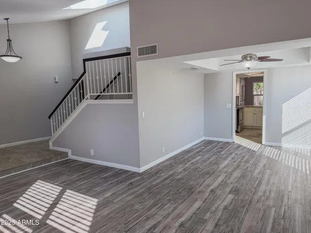 a view of a room with wooden floor and staircase