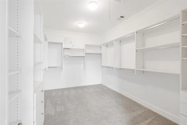 a view of a room with refrigerator and cabinet