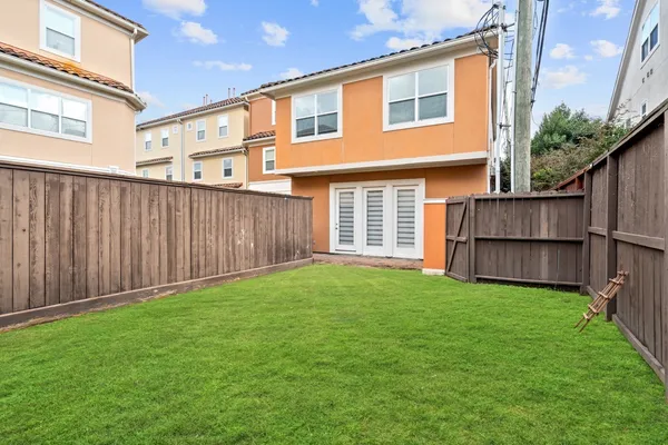 a view of backyard of house and deck