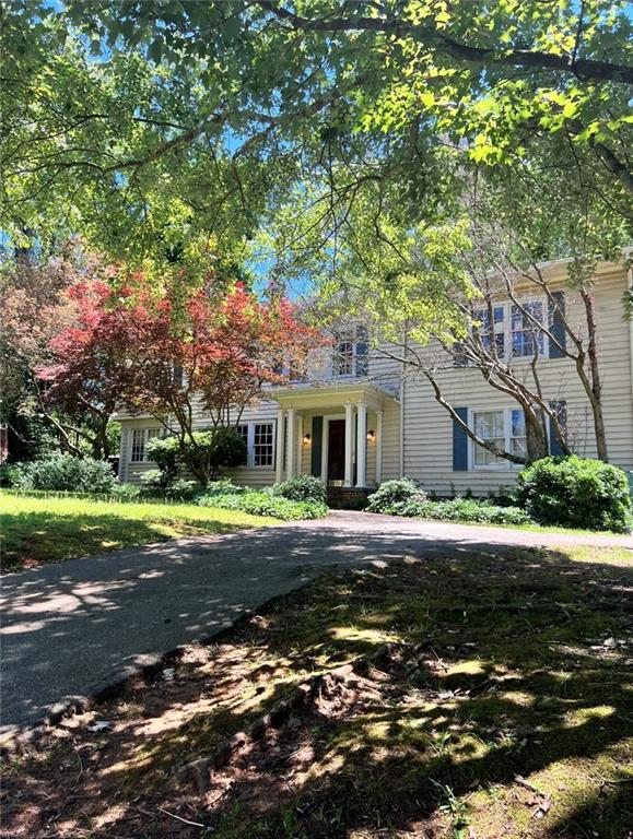 1035 Oxford Road Northeast Atlanta, GA 30306 - Photo 1 of 1 a front view of a house with a big yard