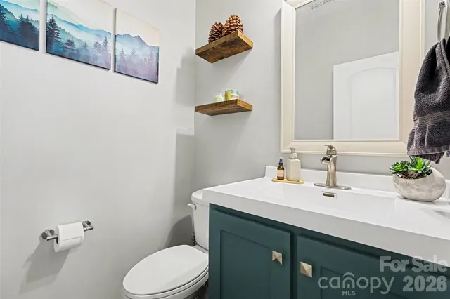 a bathroom with a sink a toilet and mirror