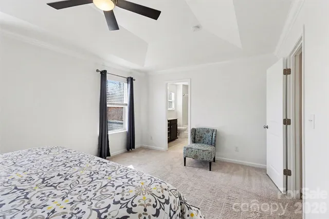 a bedroom with a bed and a chair