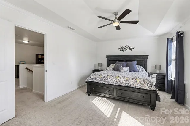 a bedroom with a bed and a ceiling fan