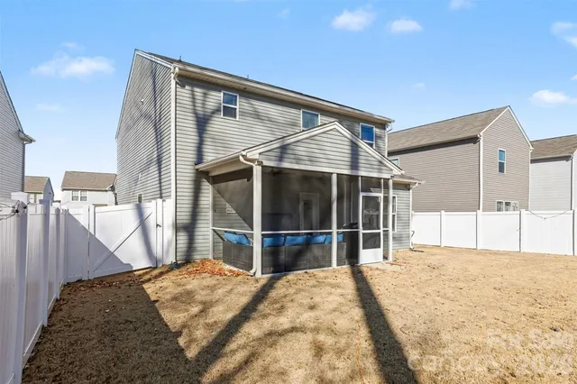 a bedroom with a bed and a flat tv screen next to a window