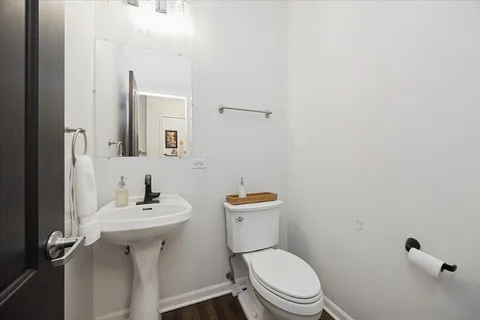 a white toilet sitting next to a bathroom sink