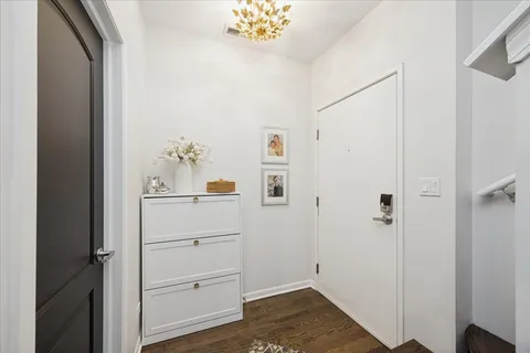 a view of a bedroom with wooden floor