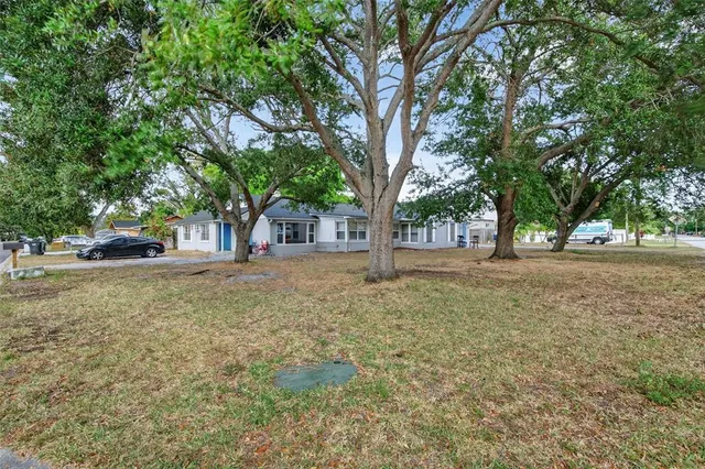 a view of outdoor space with garden and trees