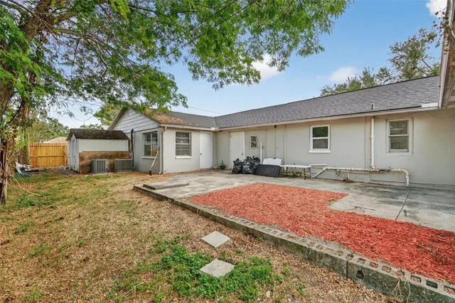 a front view of house with yard and trees