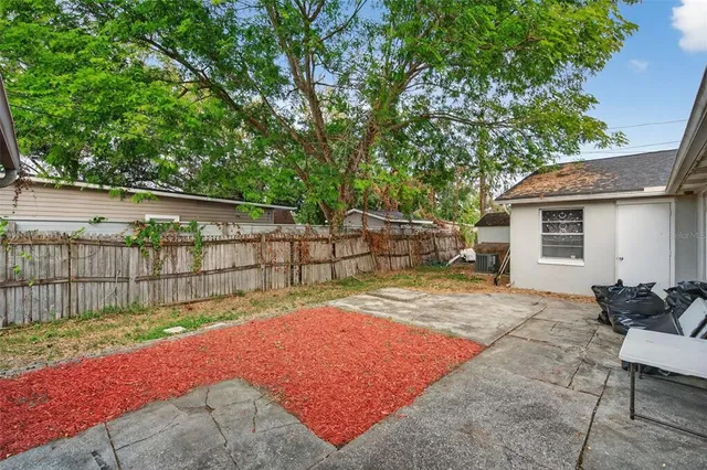 a backyard of a house with table and chairs