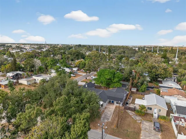 an aerial view of a houses with city view