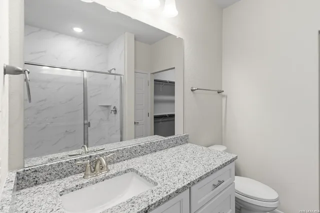 a bathroom with a shower and a toilet