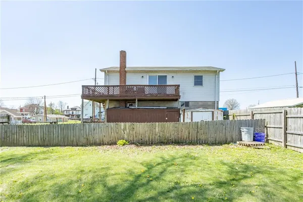 a view of a terrace with a wooden fence