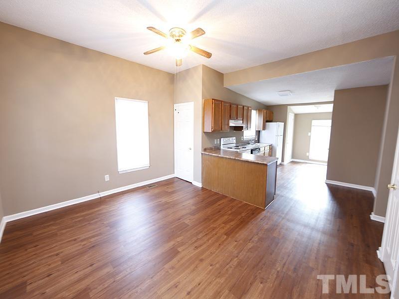 919 Dale Street Durham, NC 27701 - Photo 3 of 16 a view of a kitchen with a sink a refrigerator and wooden floor