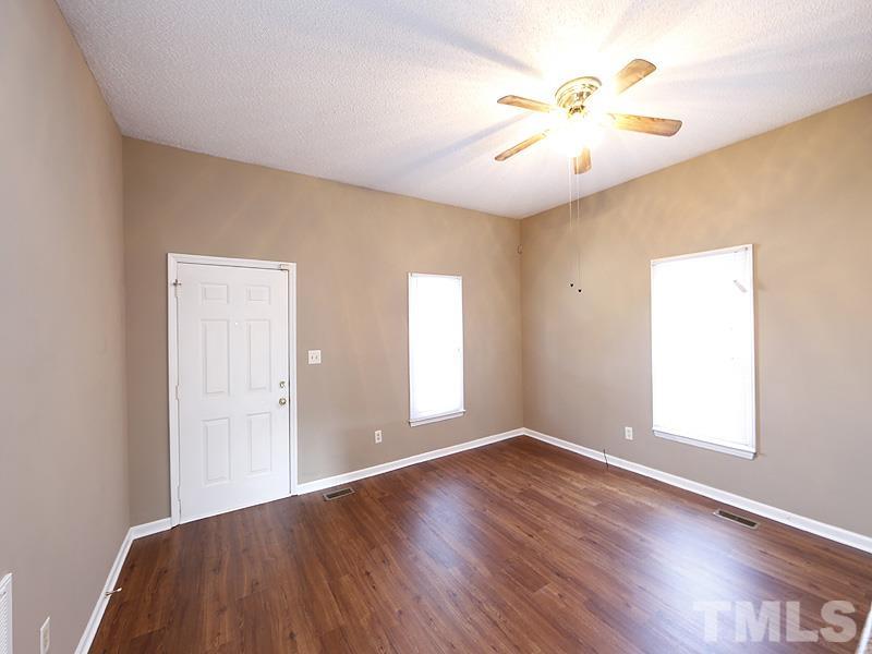 919 Dale Street Durham, NC 27701 - Photo 4 of 16 an empty room with wooden floor and windows