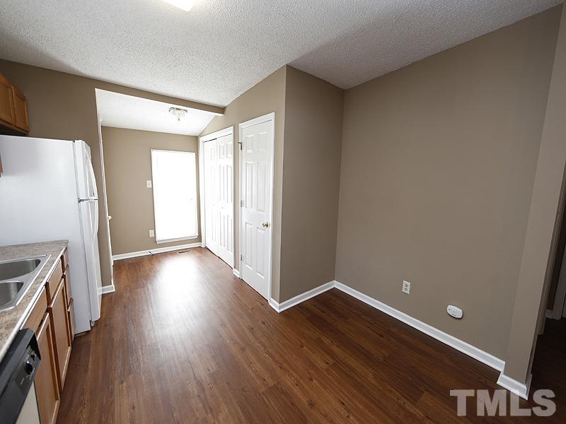 919 Dale Street Durham, NC 27701 - Photo 6 of 16 a view of a kitchen with wooden floor and a refrigerator