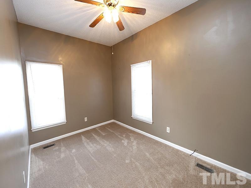 919 Dale Street Durham, NC 27701 - Photo 7 of 16 an empty room with windows and fan