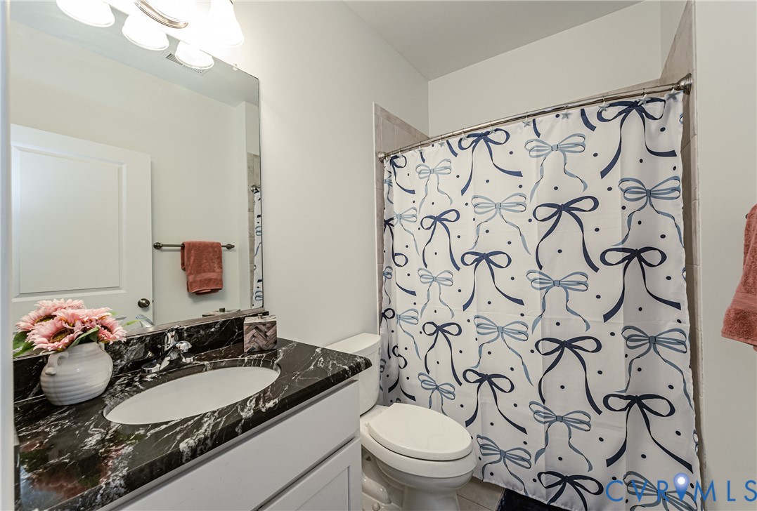 2018 Valentine Road Henrico, VA 23228 - Photo 28 of 65 a bathroom with a granite countertop sink and a mirror