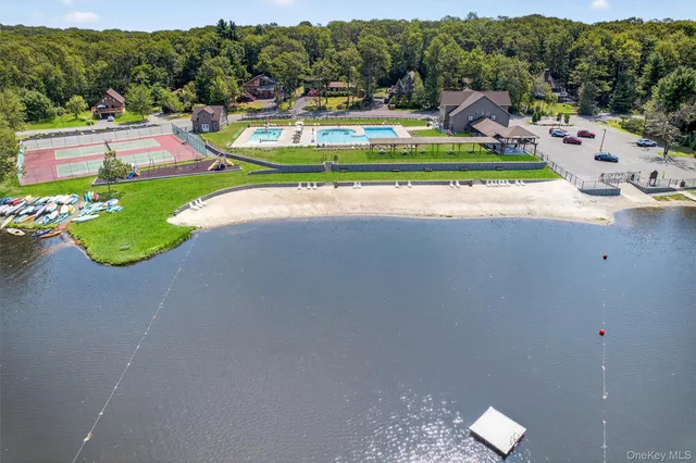 an aerial view of a house with swimming pool garden and seating area