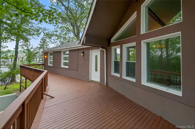 a view of backyard with large trees and wooden floor