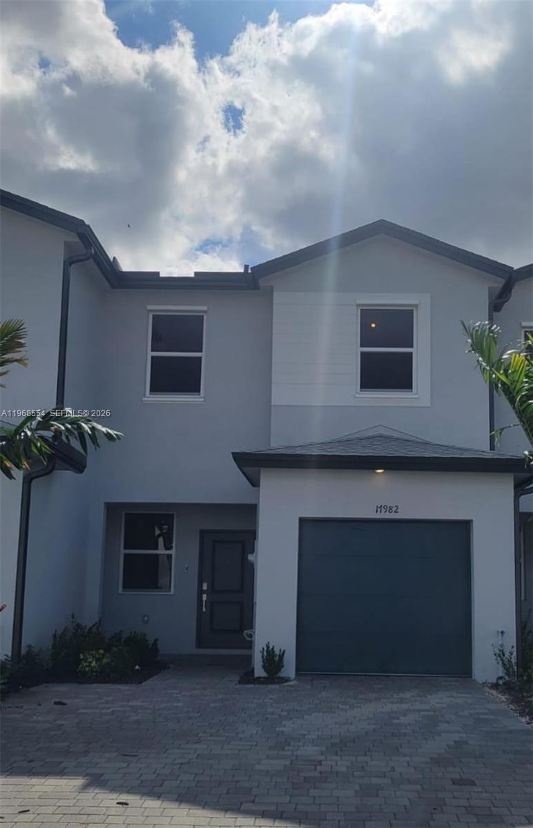 a front view of a house with a garage