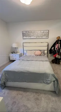 a bedroom with a bed and a lamp