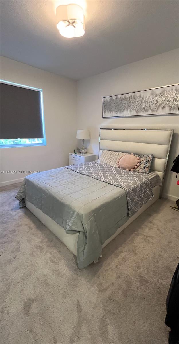 17982 Southwest 359th Street Homestead, FL 33034 - Photo 13 of 17 a bedroom with a bed and a night stand