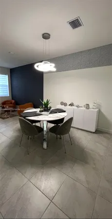 a room with furniture and a potted plant