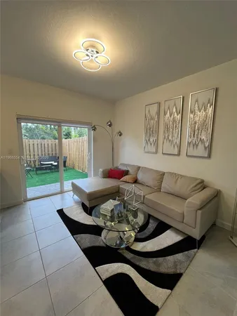 a living room with furniture and a backyard