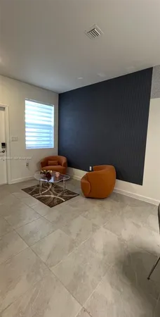 a view of a room with a table and a couch