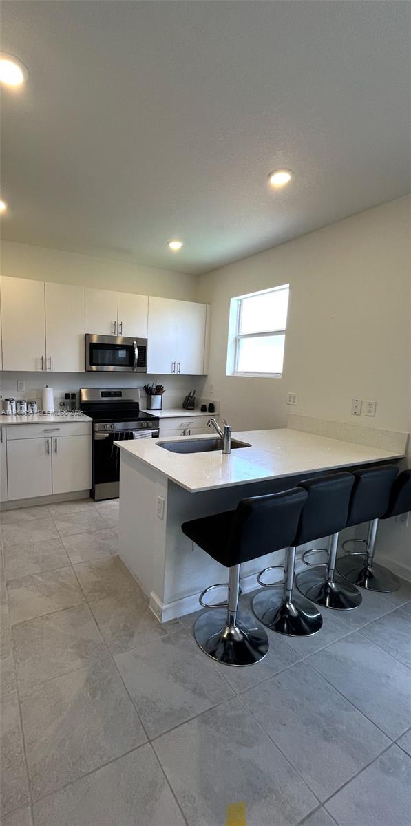 17982 Southwest 359th Street Homestead, FL 33034 - Photo 9 of 17 a kitchen with a sink refrigerator and cabinets