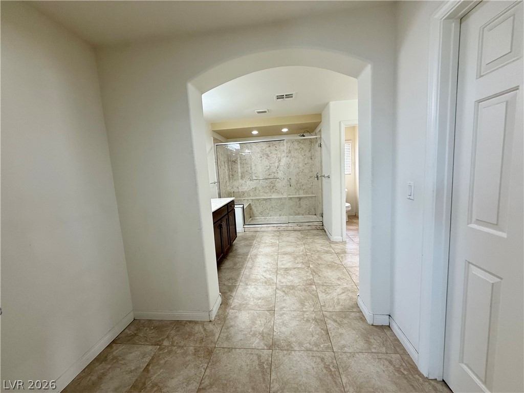 6459 Parrot Ridge Court Las Vegas, NV 89139 - Photo 16 of 23 An inviting bathroom offers a spacious walk-in shower and elegant tile flooring. Walk in closet door to right.