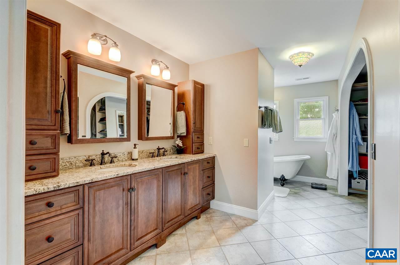 145 Ivy Ridge Road Charlottesville, VA 22901 - Photo 35 of 50 a spacious bathroom with a double vanity sink and mirror
