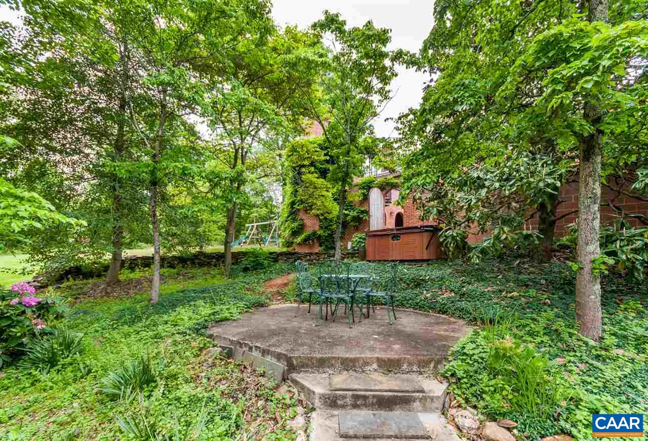 145 Ivy Ridge Road Charlottesville, VA 22901 - Photo 44 of 50 a backyard of a house with a garden and trees