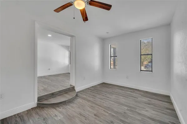 wooden floor in an empty room with a window