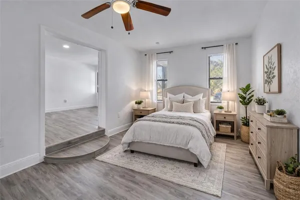 a bedroom with a large bed and a chandelier