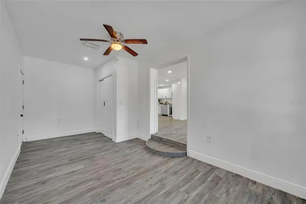 a view of empty room with wooden floor