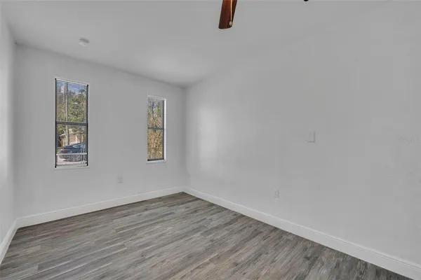 a view of a room with wooden floor and window