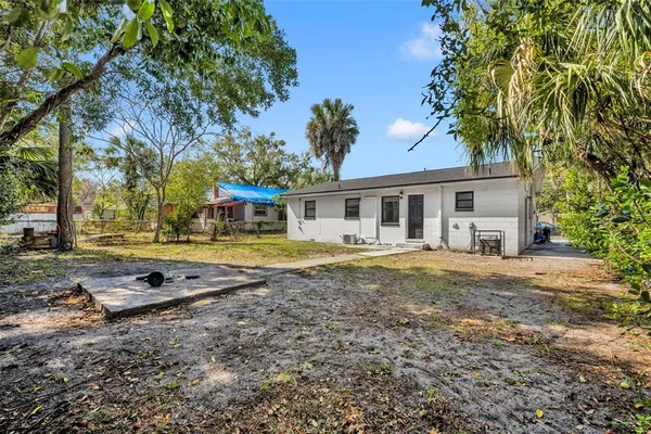 a view of a house with backyard and sitting area