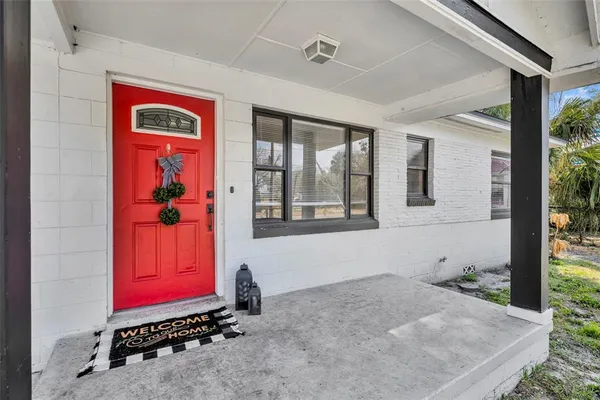 a front view of a house with a red gate