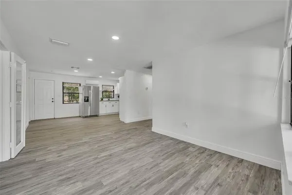 a view of an empty room with wooden floor