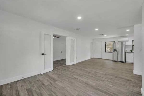 a view of empty room with wooden floor