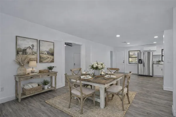a view of a dining room with furniture and wooden floor
