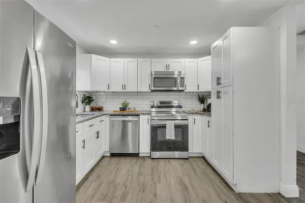 a kitchen with stainless steel appliances a refrigerator sink and stove