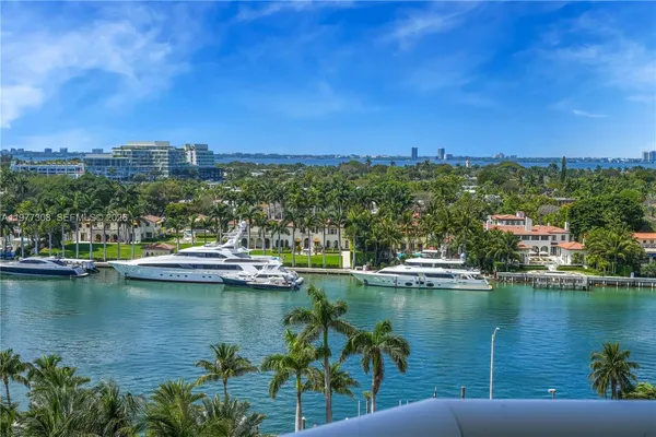 a large white kitchen with a large window