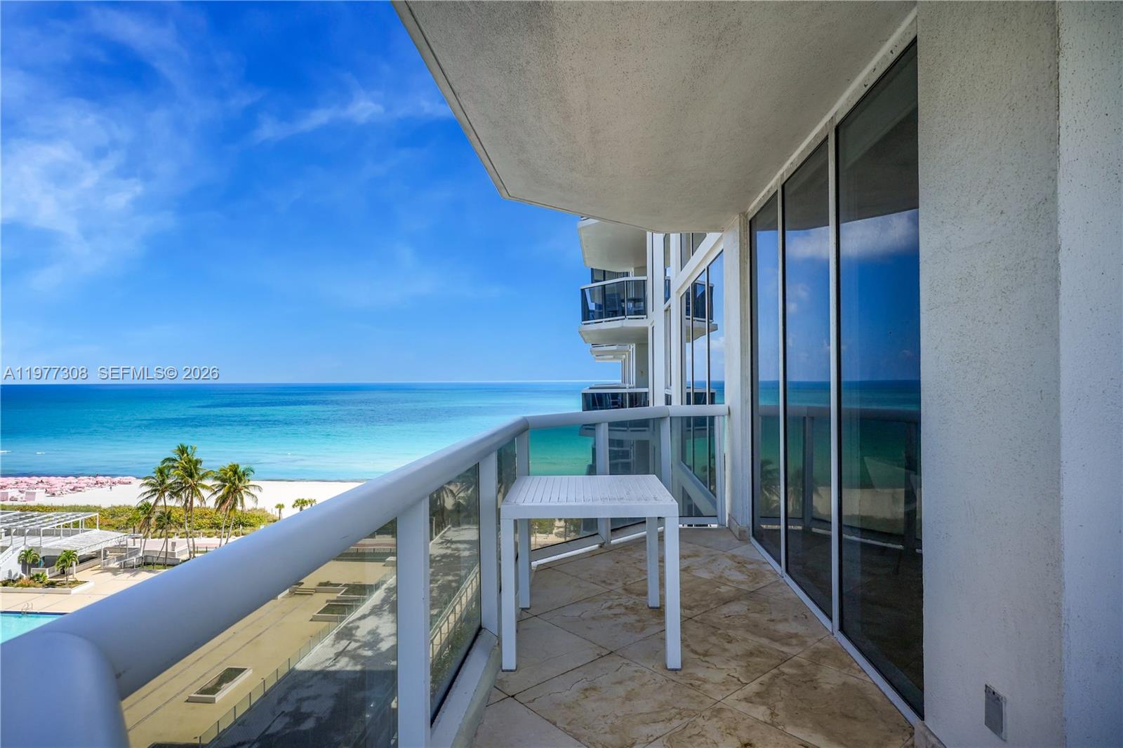 4779 Collins Avenue, Unit 1007 Miami Beach, FL 33140 - Photo 2 of 56 a view of balcony with wooden floor and seating space