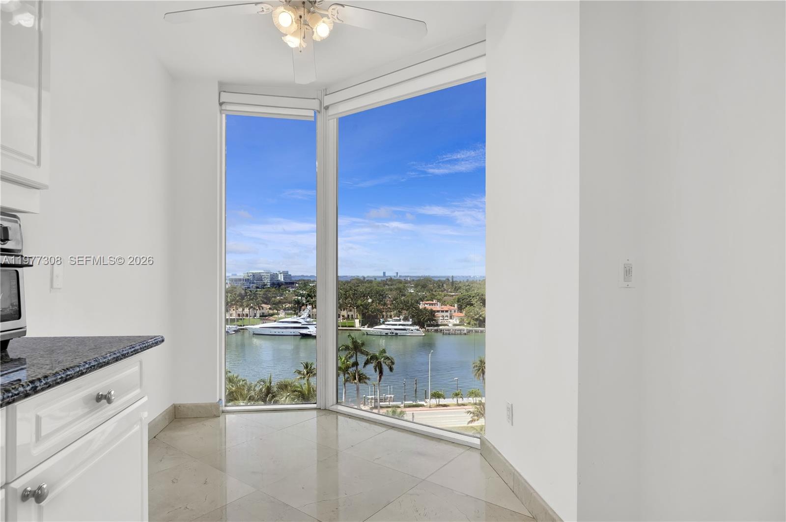 4779 Collins Avenue, Unit 1007 Miami Beach, FL 33140 - Photo 21 of 56 a view of a kitchen with a sink and a large window