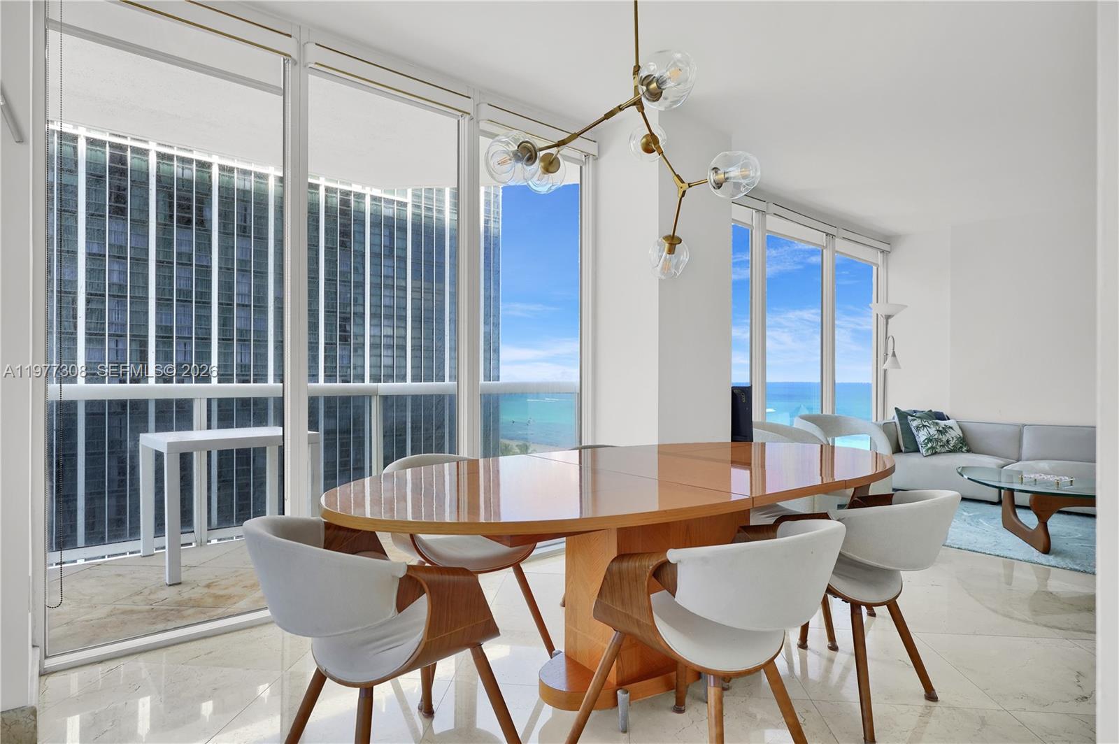 4779 Collins Avenue, Unit 1007 Miami Beach, FL 33140 - Photo 23 of 56 a view of a dining room with furniture and a window