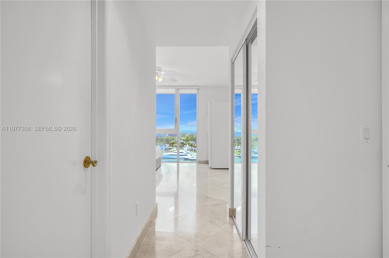 4779 Collins Avenue, Unit 1007 Miami Beach, FL 33140 - Photo 24 of 56 a view of a hallway with wooden floor and windows